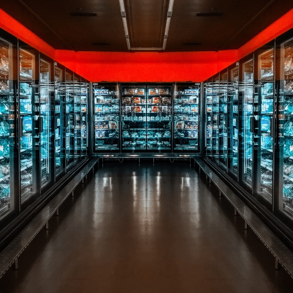 Grocery freezer aisle with glass-door reach-in cases